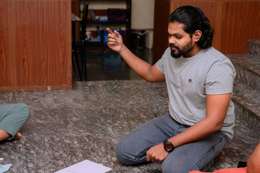 Facilitator gesturing while leading a discussion