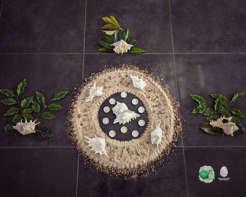 A shell and candle mandala arrangement used in the session